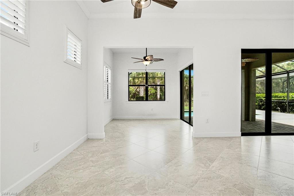 9395 Greyhawk Trail Naples, FL 34120 - Photo 12 of 37 an empty room with windows and ceiling fan