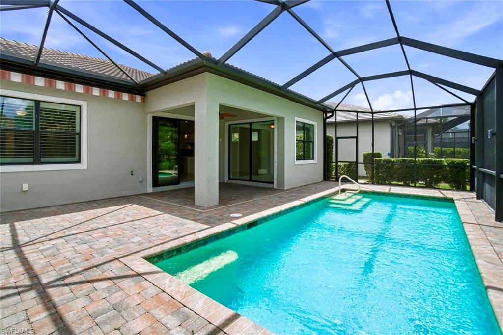 9395 Greyhawk Trail Naples, FL 34120 - Photo 14 of 37 a view of a house with backyard porch and sitting area