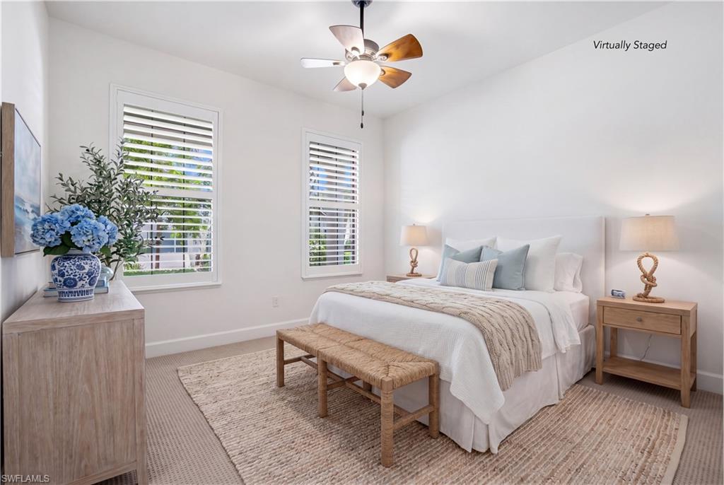 9395 Greyhawk Trail Naples, FL 34120 - Photo 21 of 37 a bedroom with bed and a chandelier