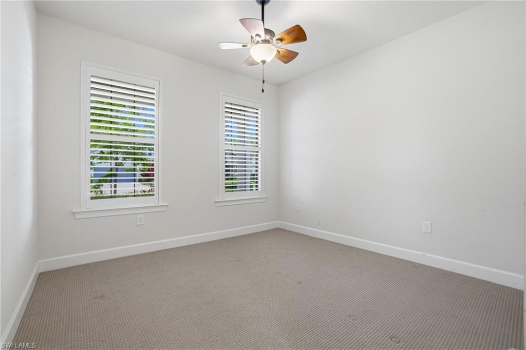 9395 Greyhawk Trail Naples, FL 34120 - Photo 22 of 37 an empty room with windows and fan