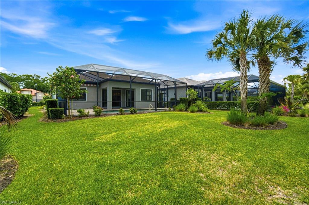 9395 Greyhawk Trail Naples, FL 34120 - Photo 28 of 37 a front view of house with yard and green space