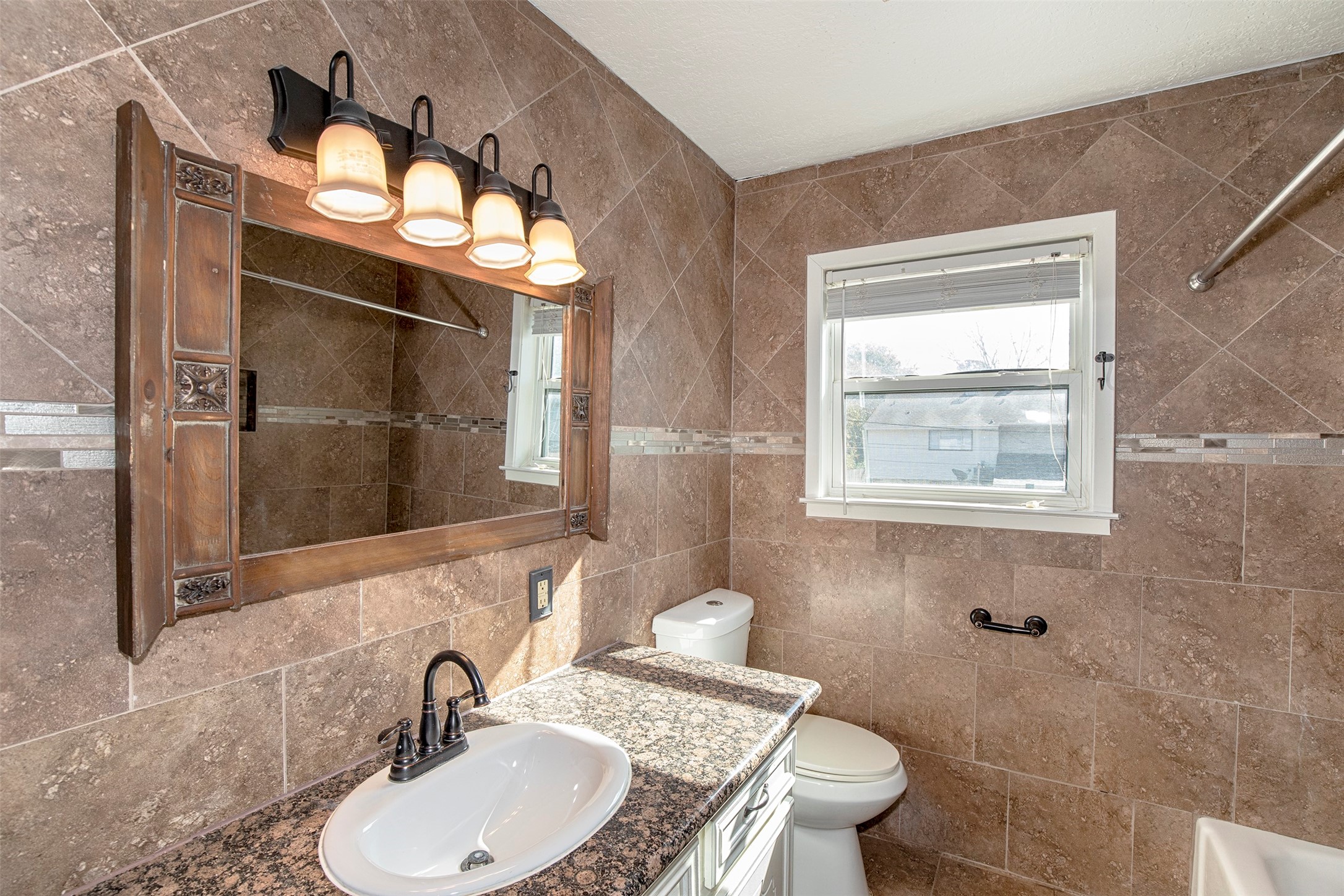 431 Sunset Drive, Unit 2 Dickinson, TX 77539 - Photo 13 of 25 a bathroom with a toilet sink and mirror