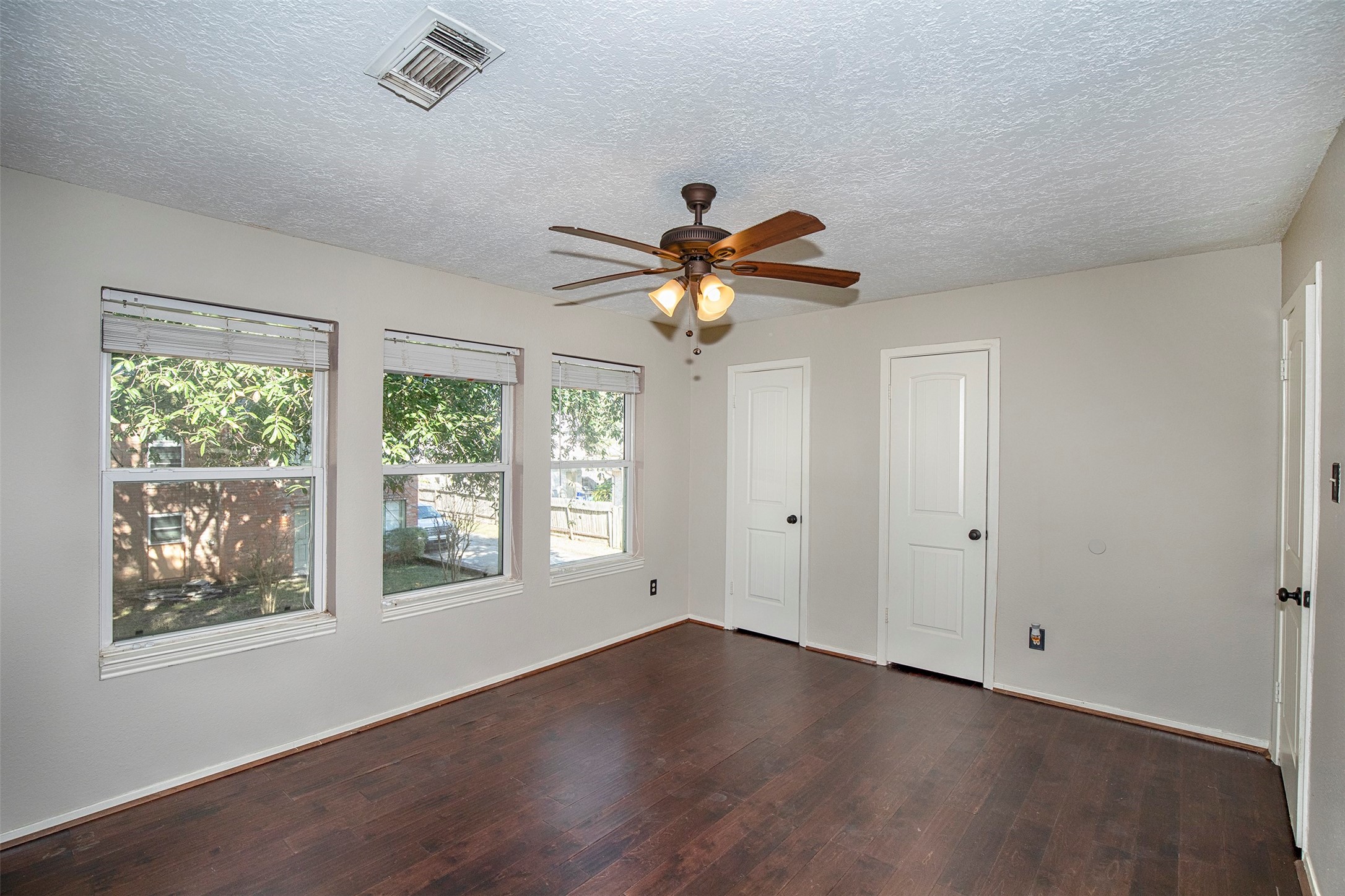 431 Sunset Drive, Unit 2 Dickinson, TX 77539 - Photo 15 of 25 a view of an empty room with wooden floor and a window