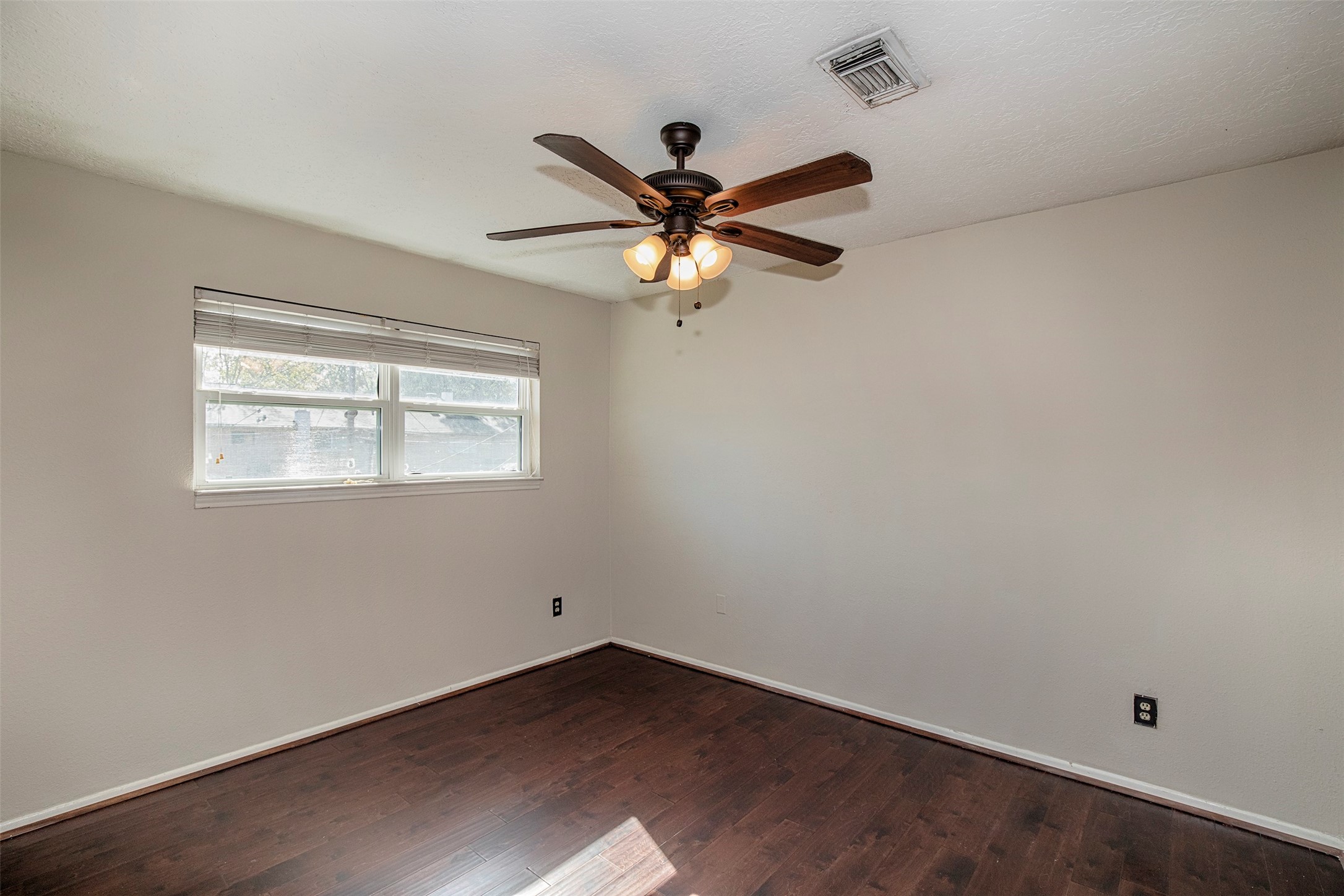 431 Sunset Drive, Unit 2 Dickinson, TX 77539 - Photo 18 of 25 an empty room with a window and a fan