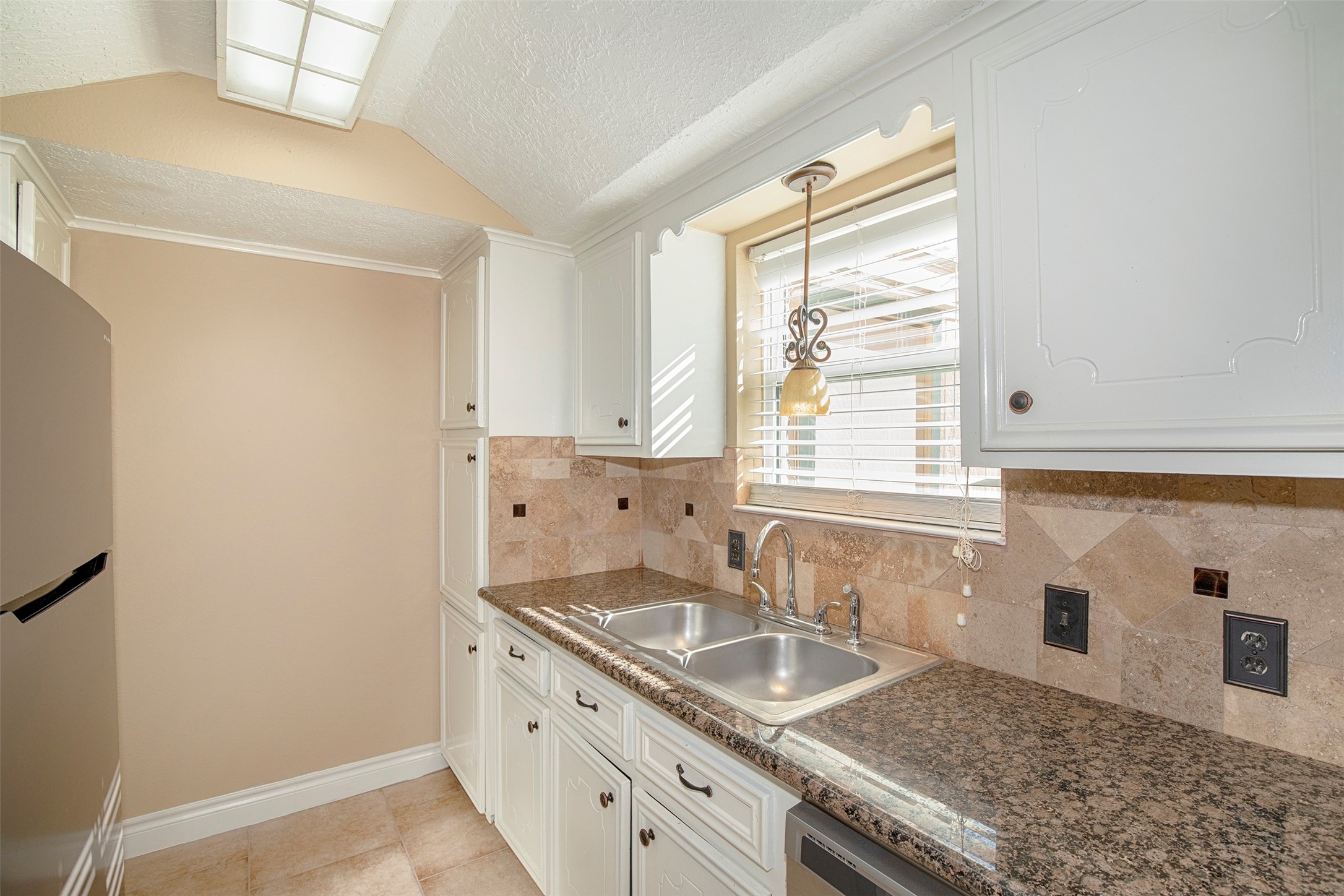 431 Sunset Drive, Unit 2 Dickinson, TX 77539 - Photo 5 of 25 a kitchen with granite countertop a sink and a stove
