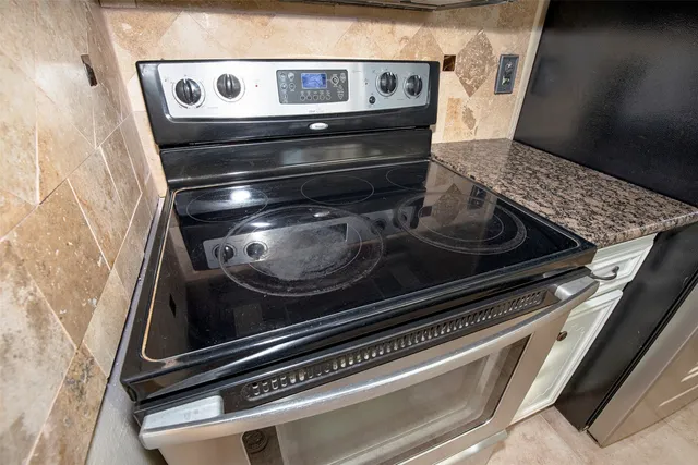 a stove top oven sitting inside of a kitchen