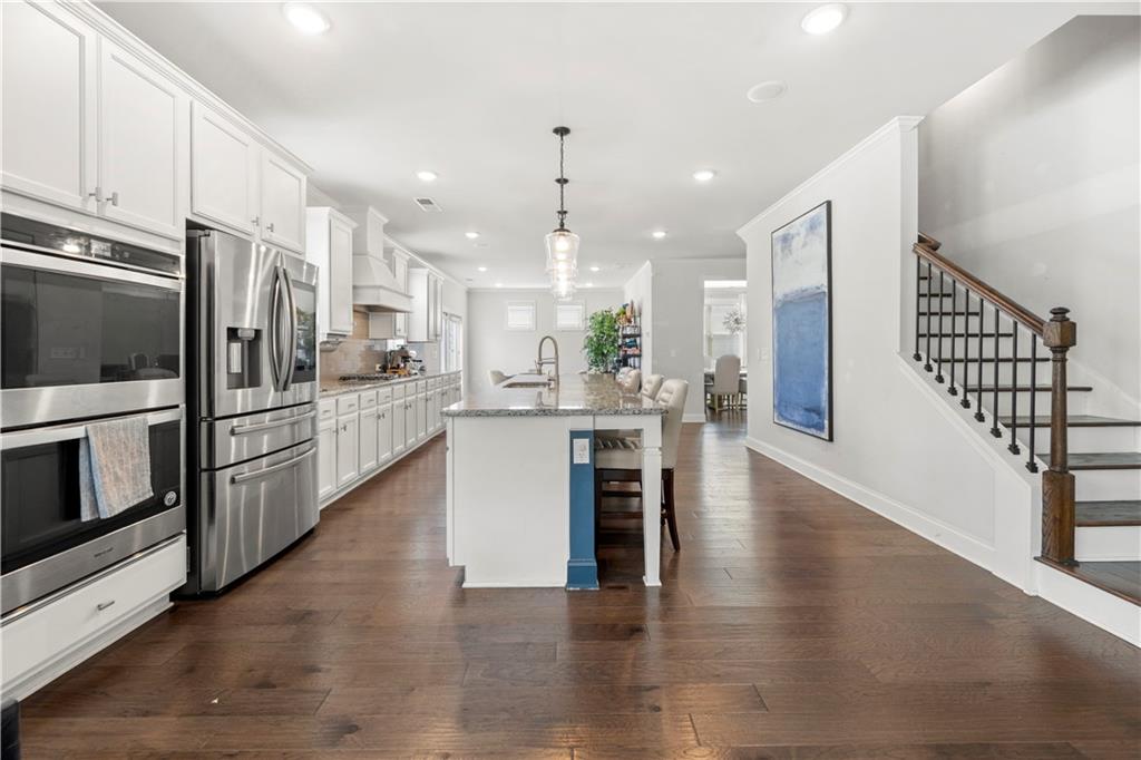 130 Sycamore Row Atlanta, GA 30331 - Photo 15 of 42 a kitchen with stainless steel appliances kitchen island granite countertop a refrigerator and a stove top oven
