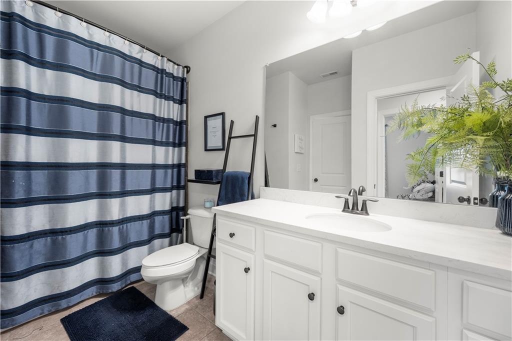 130 Sycamore Row Atlanta, GA 30331 - Photo 18 of 42 a bathroom with a sink a toilet and shower curtain