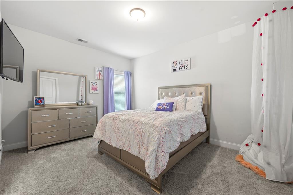 130 Sycamore Row Atlanta, GA 30331 - Photo 23 of 42 a bedroom with a bed and a dresser