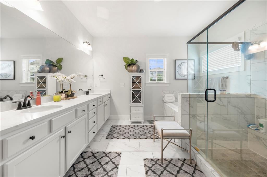130 Sycamore Row Atlanta, GA 30331 - Photo 28 of 42 a bathroom with a double vanity sink a toilet and shower