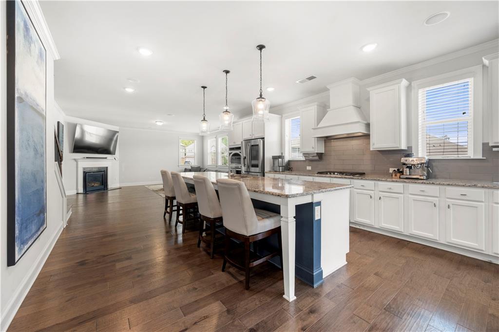 130 Sycamore Row Atlanta, GA 30331 - Photo 9 of 42 a large kitchen with kitchen island granite countertop a sink a counter space and stainless steel appliances