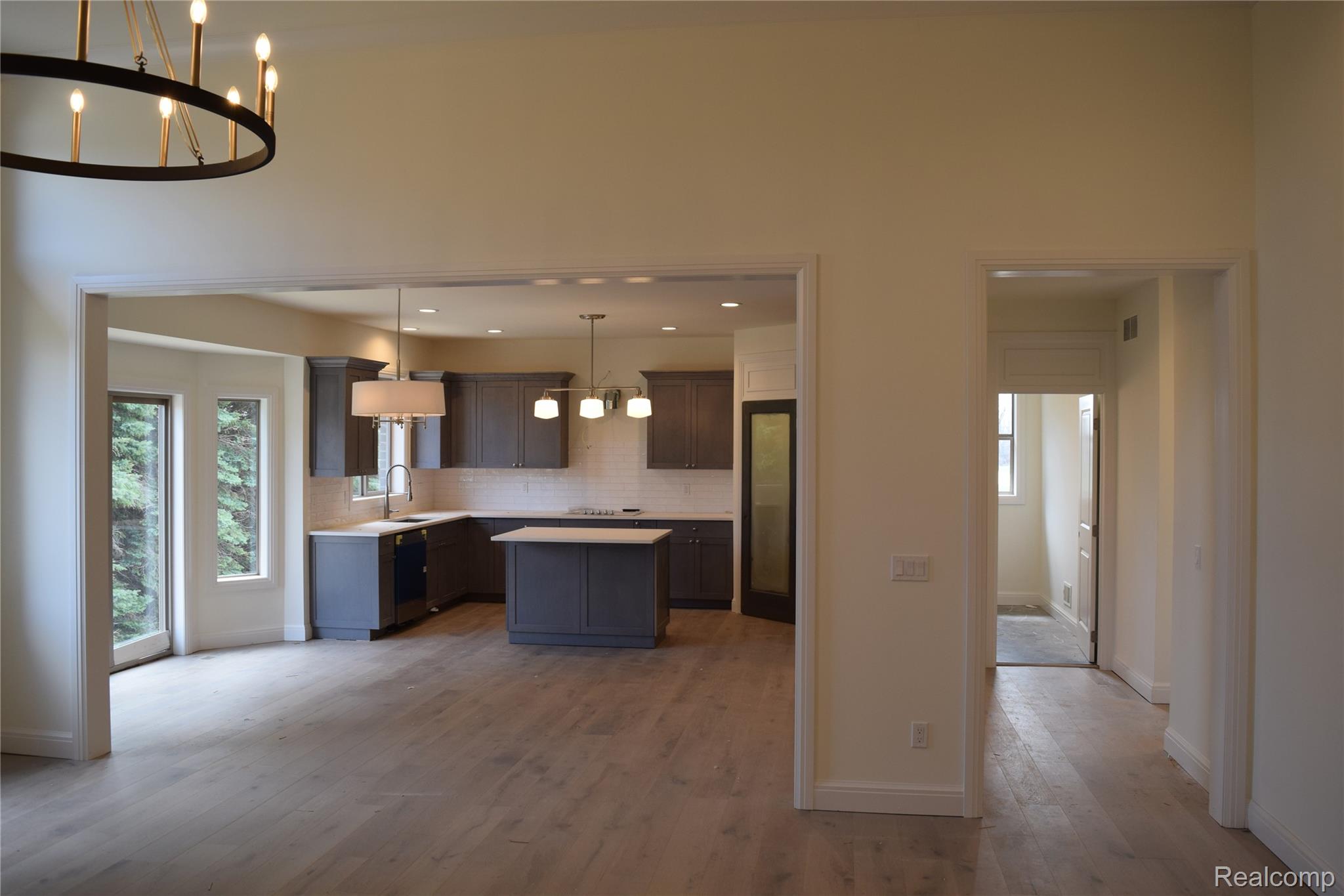 3093 Raffler Drive Rochester, MI 48307 - Photo 18 of 34 Kitchen with a chandelier, a center island, light countertops, pendant lighting, and light wood flooring