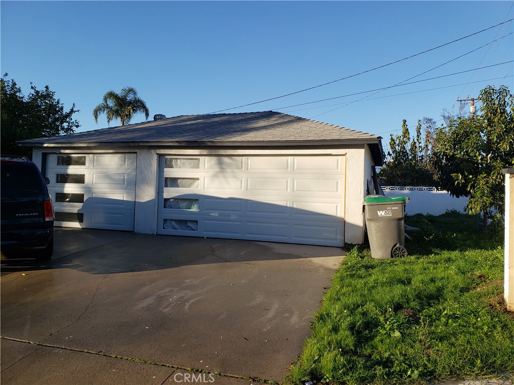 13185 14th Street Chino, CA 91710 - Photo 17 of 42 a front view of a house with yard and garage