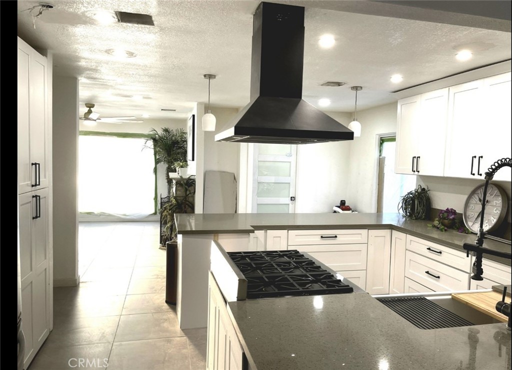 13185 14th Street Chino, CA 91710 - Photo 24 of 42 a kitchen with stainless steel appliances a sink a stove and a refrigerator