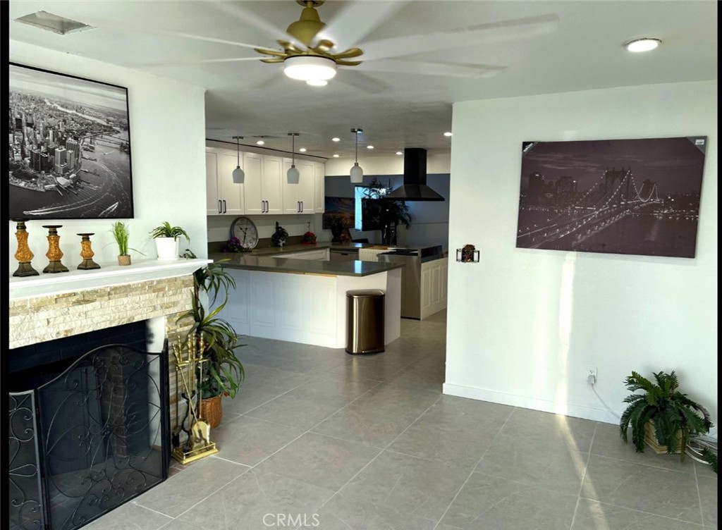 13185 14th Street Chino, CA 91710 - Photo 37 of 42 a kitchen with stainless steel appliances kitchen island granite countertop a sink and a stove