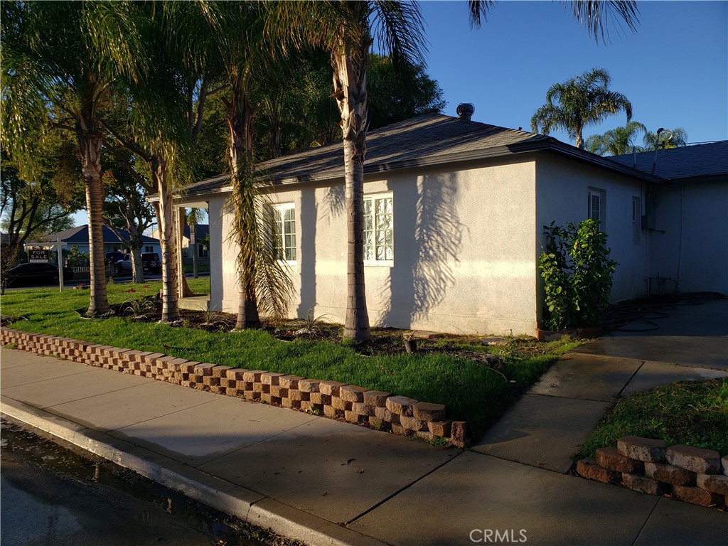 13185 14th Street Chino, CA 91710 - Photo 6 of 42 a view of a wooden door with a bench in patio