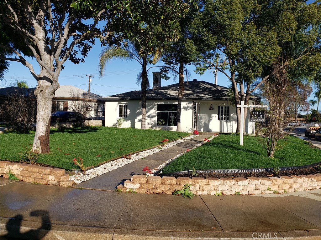 13185 14th Street Chino, CA 91710 - Photo 8 of 42 a front view of a house with a yard