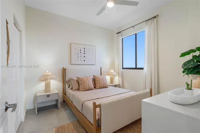 a bedroom with a bed and a lamp