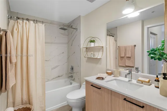 a bathroom with a sink toilet tub and shower