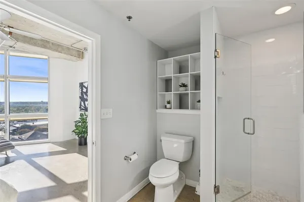 a bathroom with a toilet and a shower