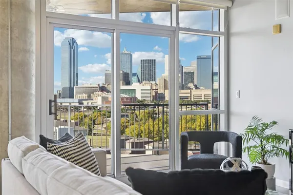 a living room with furniture and a floor to ceiling window
