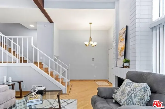 a kitchen with a sink and wooden floor