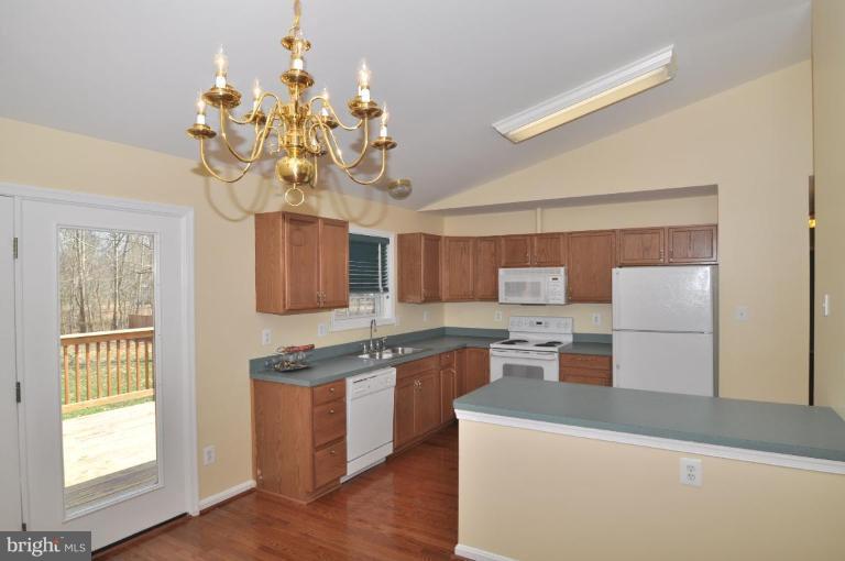 7401 Bull Run Road Manassas, VA 20111 - Photo 6 of 22 a kitchen with kitchen island granite countertop stainless steel appliances a counter space and a window