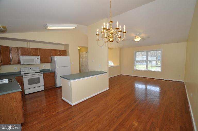 7401 Bull Run Road Manassas, VA 20111 - Photo 8 of 22 a view of a kitchen with microwave and wooden floor