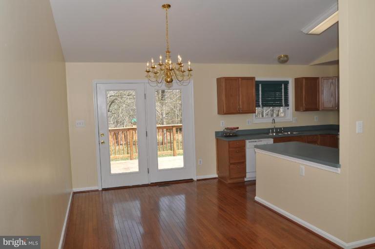 7401 Bull Run Road Manassas, VA 20111 - Photo 9 of 22 a kitchen with stainless steel appliances granite countertop a sink cabinets and wooden floor
