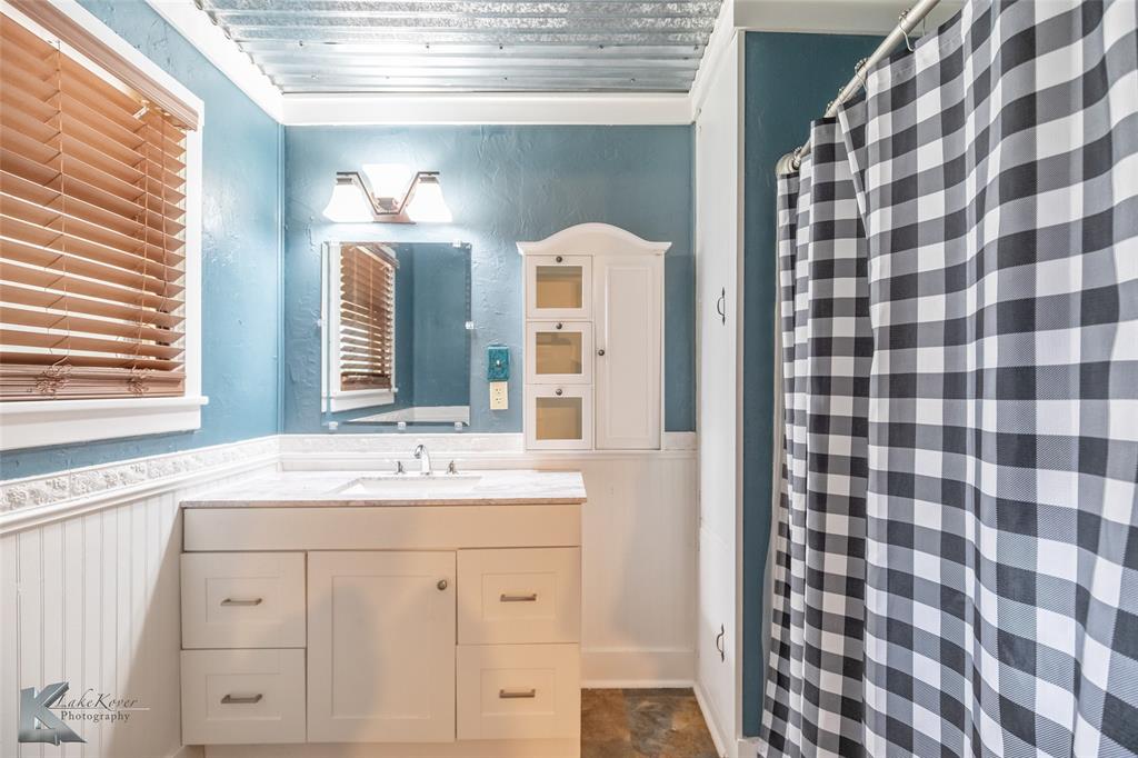 801 Highway 153 Wingate, TX 79566 - Photo 21 of 39 a bathroom with a sink and a mirror