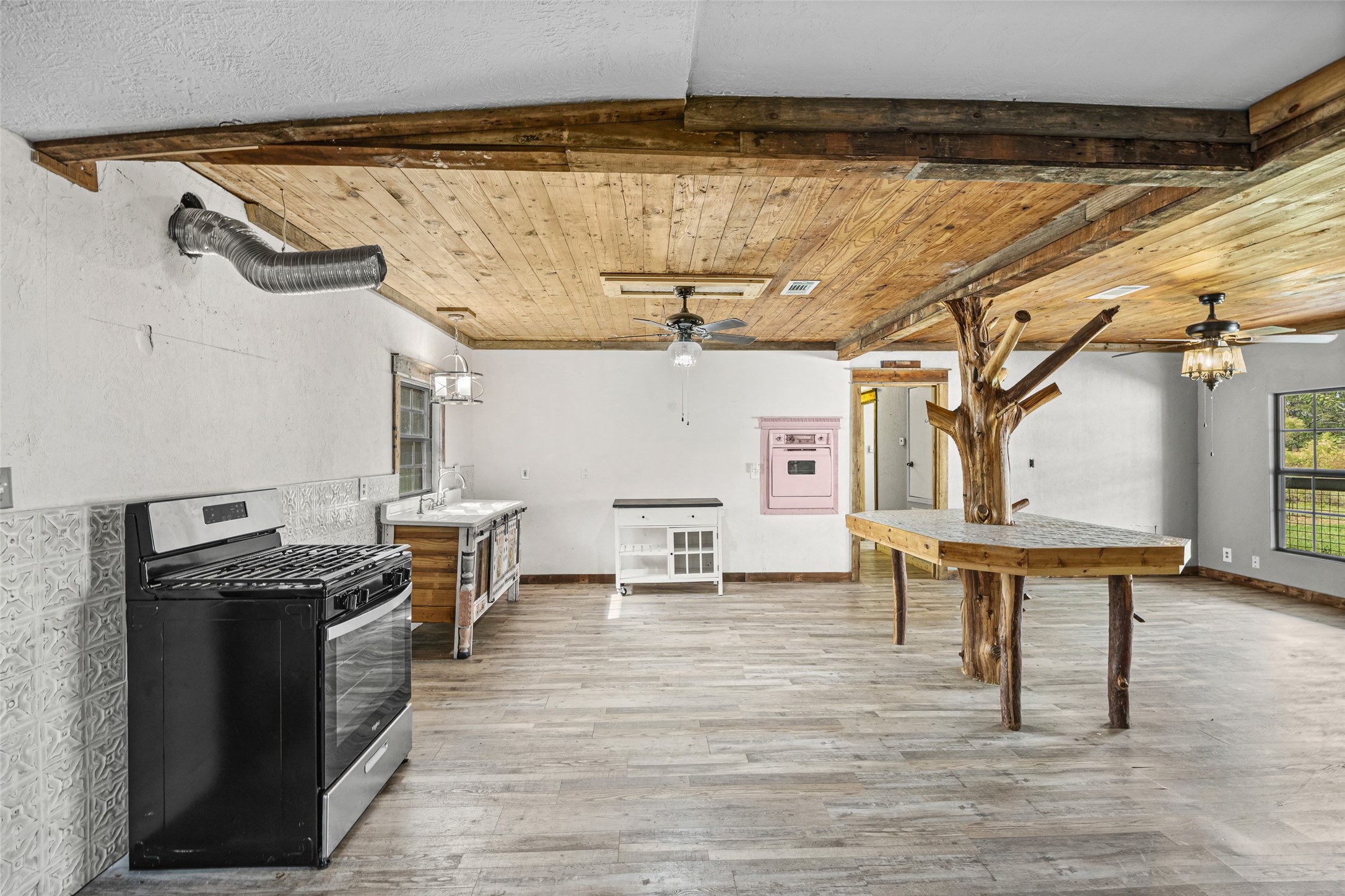 577 County Road 138 Jasper, TX 75951 - Photo 19 of 45 a kitchen with stainless steel appliances wooden floor and a table