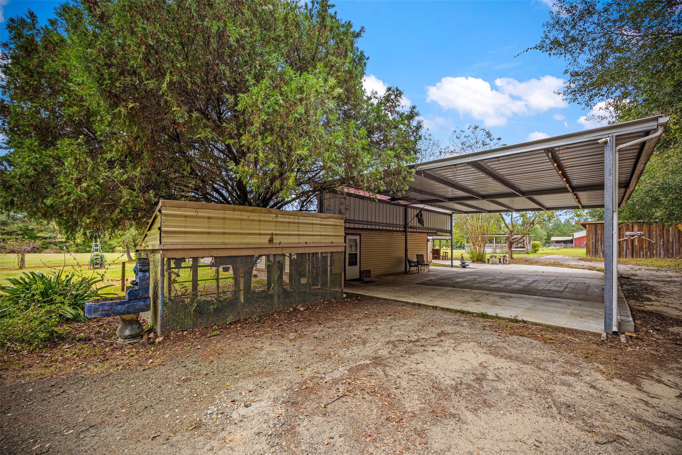 577 County Road 138 Jasper, TX 75951 - Photo 9 of 45 a view of a patio with table and chairs under an umbrella with a barbeque