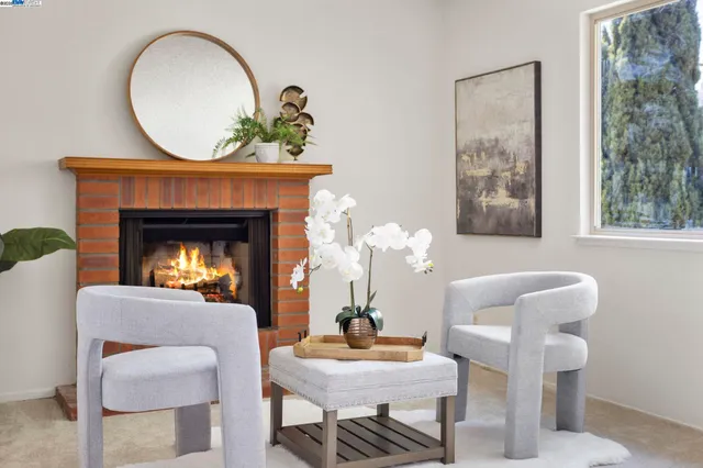 a living room with furniture a mirror and a fireplace