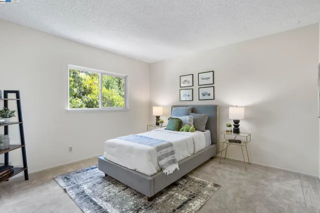 a bedroom with a bed and window