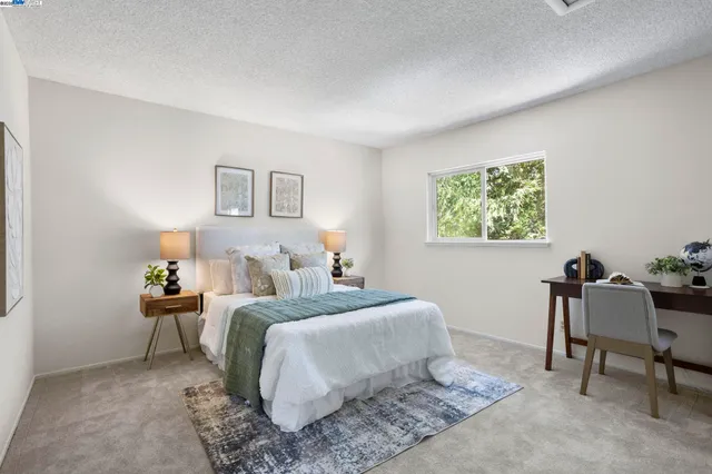 a bedroom with a bed and a desk