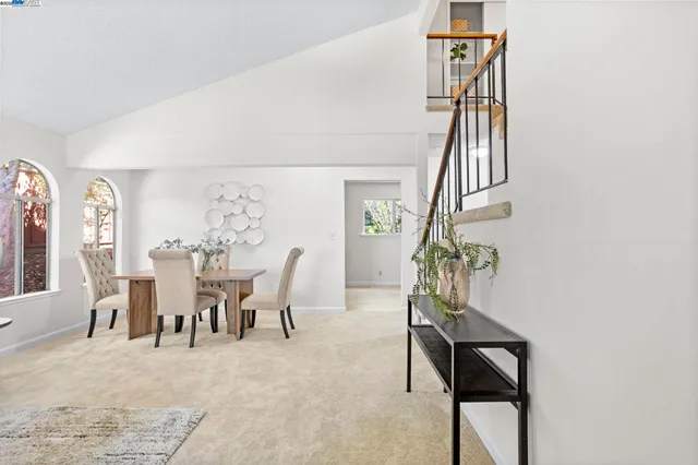 a view of a livingroom with furniture and stairs