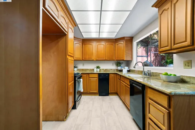 a kitchen with stainless steel appliances granite countertop a sink and cabinets