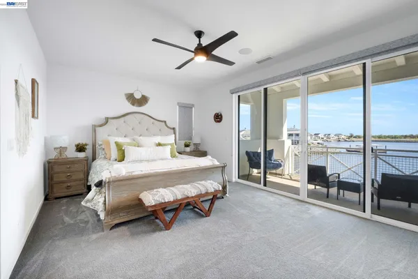 a view of a terrace with furniture and a floor to ceiling window