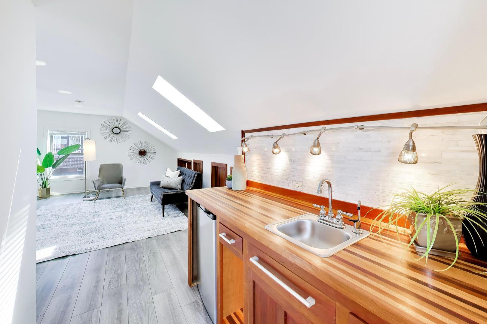 1532 West Fry Street, Unit 3 Chicago, IL 60642 - Photo 19 of 36 a living room with kitchen island granite countertop furniture a rug and white walls