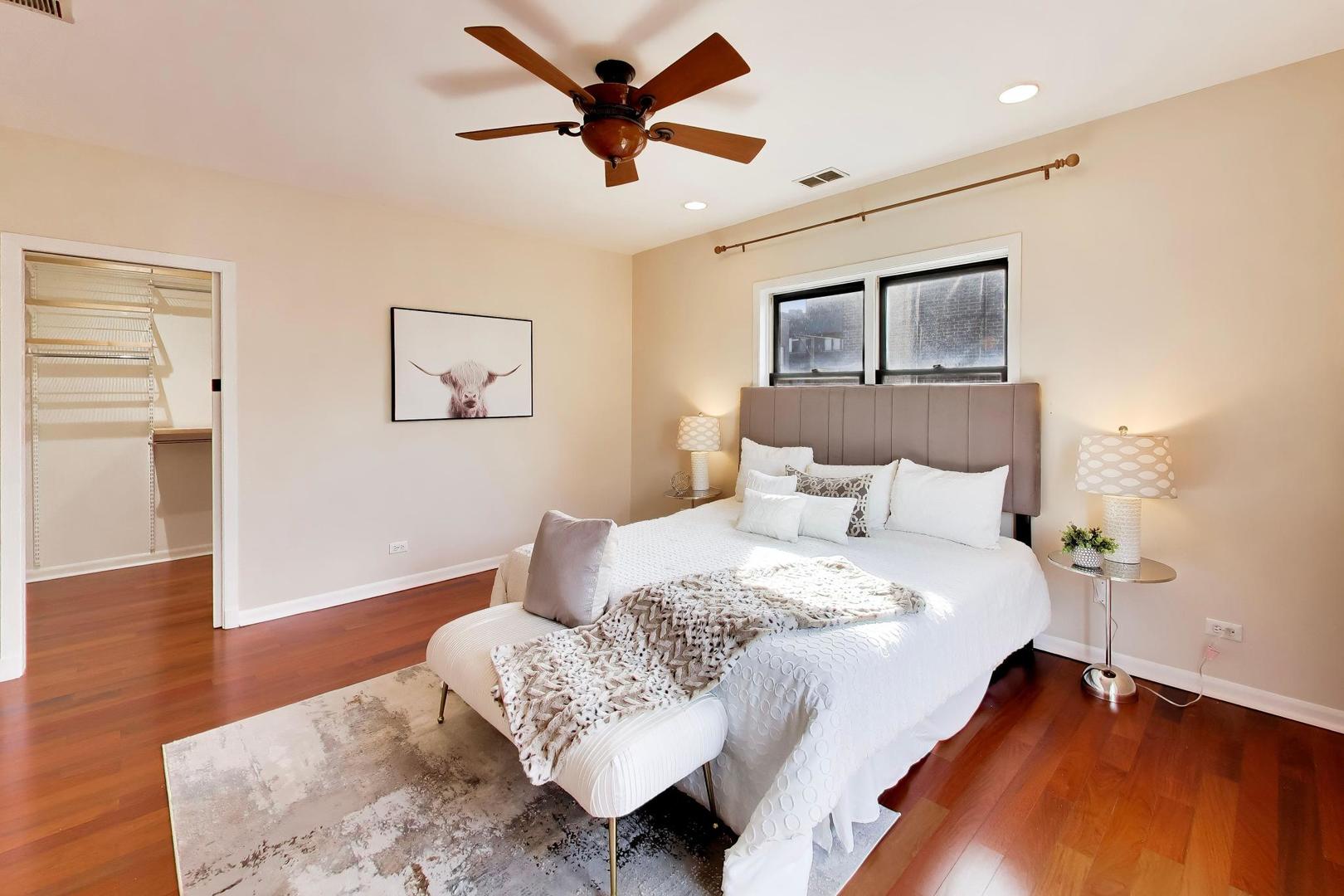 1532 West Fry Street, Unit 3 Chicago, IL 60642 - Photo 21 of 36 a bedroom with a bed and wooden floor