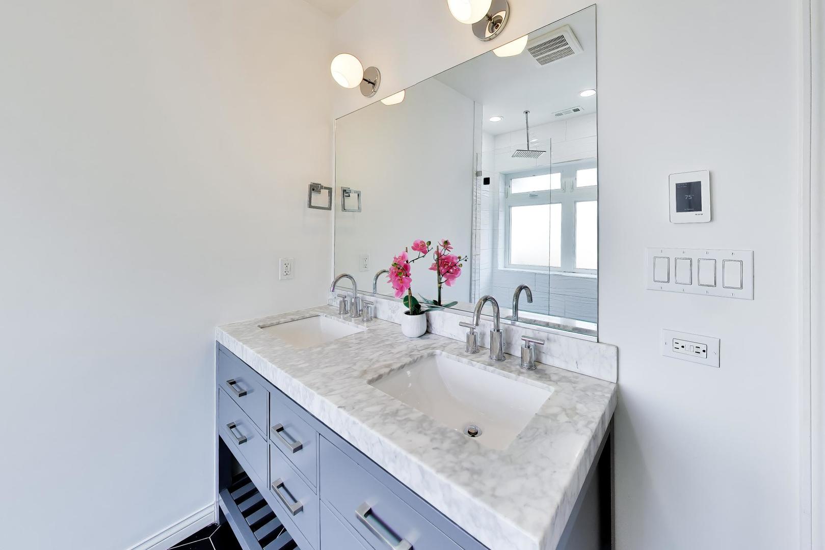 1532 West Fry Street, Unit 3 Chicago, IL 60642 - Photo 23 of 36 a bathroom with a granite countertop sink a mirror and shower