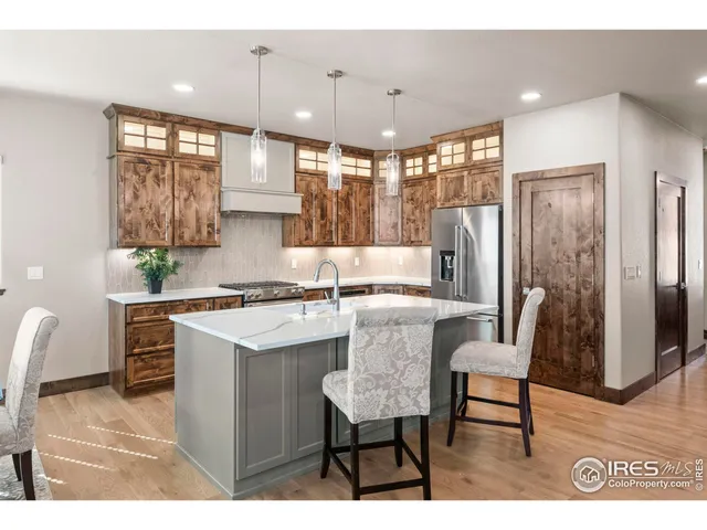 a dining room with furniture a chandelier and wooden floor