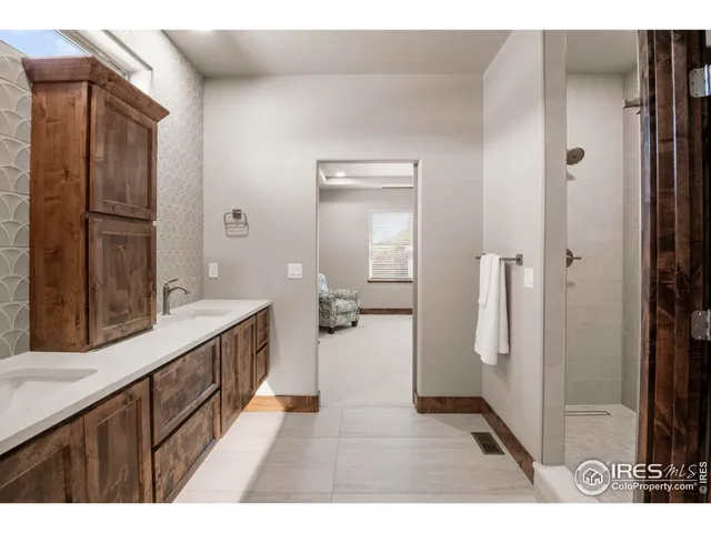 a bathroom with a sink a mirror and a shower