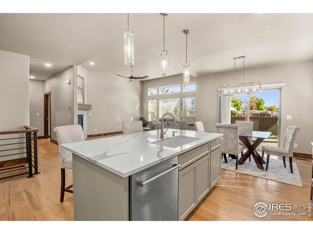 a dining room with furniture a chandelier and wooden floor