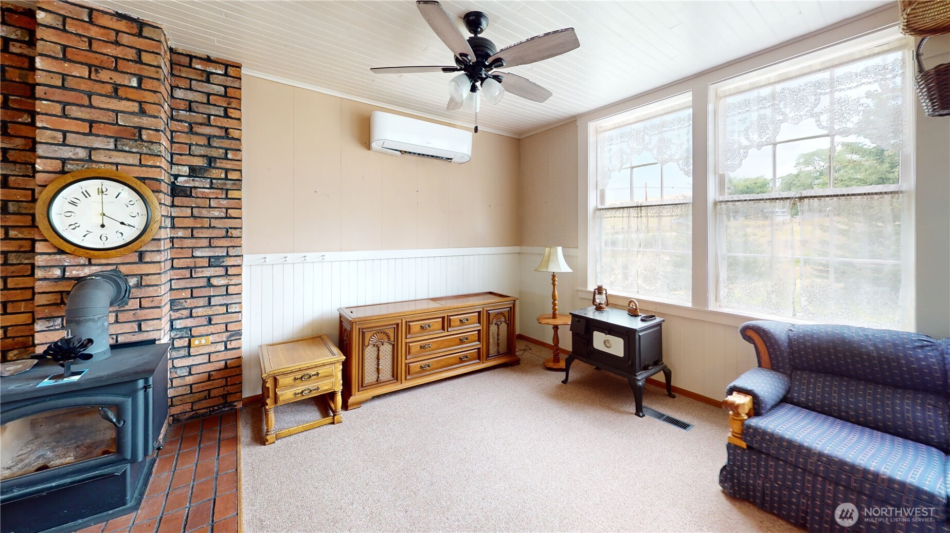7 Lost Lake Road Oroville, WA 98844 - Photo 15 of 31 a living room with furniture a fireplace and a window