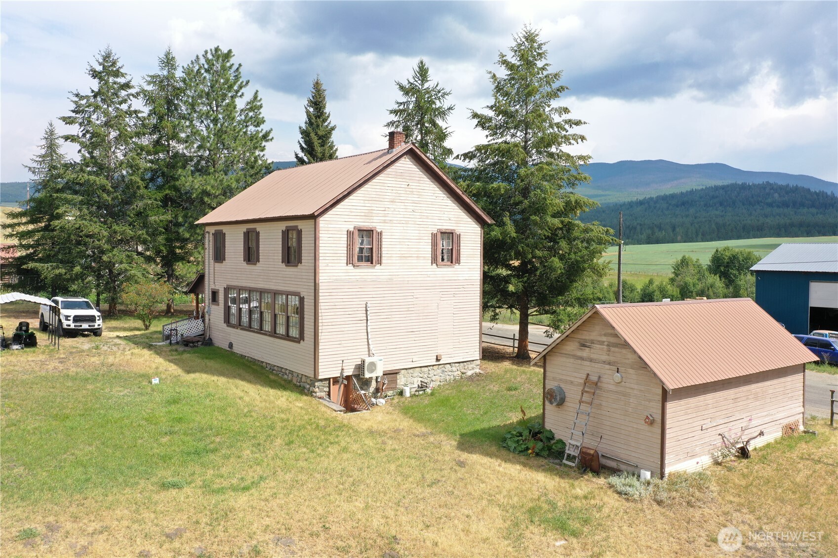 7 Lost Lake Road Oroville, WA 98844 - Photo 3 of 31 a view of a house with backyard and a garden