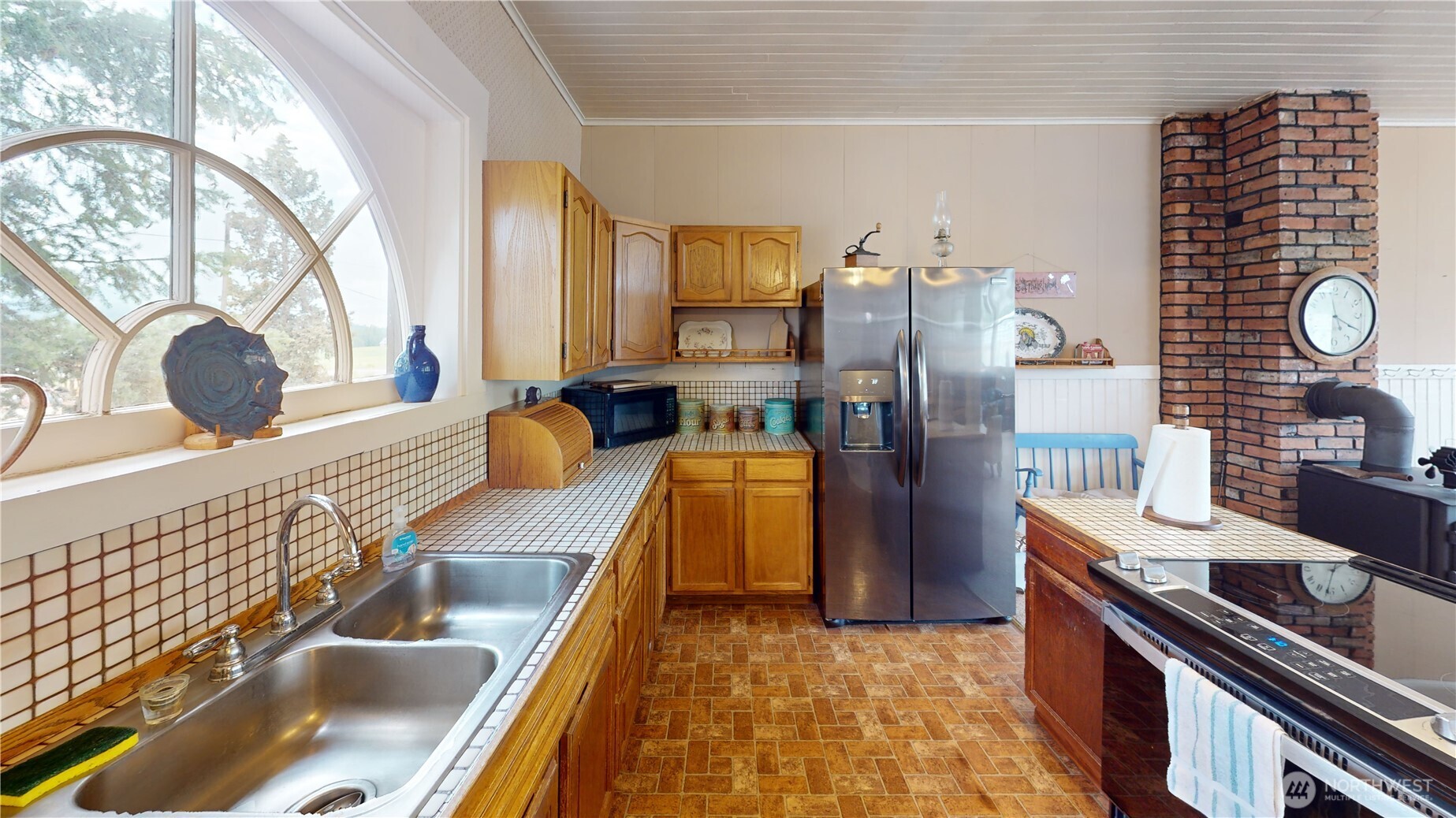 7 Lost Lake Road Oroville, WA 98844 - Photo 10 of 31 a kitchen with stainless steel appliances kitchen island granite countertop a refrigerator and a stove