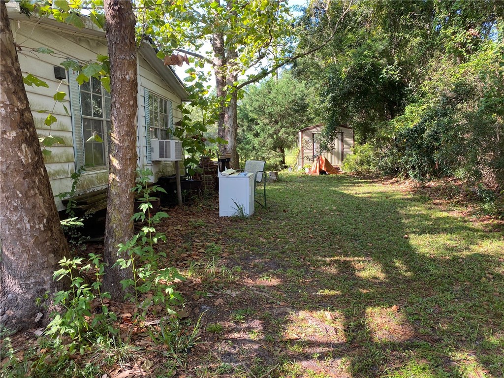 96105 Durden Road Yulee, FL 32097 - Photo 4 of 10 a backyard of a house with fountain and barbeque oven