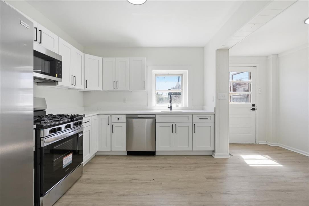 812 Linden Street Bethlehem, PA 18018 - Photo 5 of 39 A well-lit kitchen with sleek white cabinetry and modern stainless steel appliances.