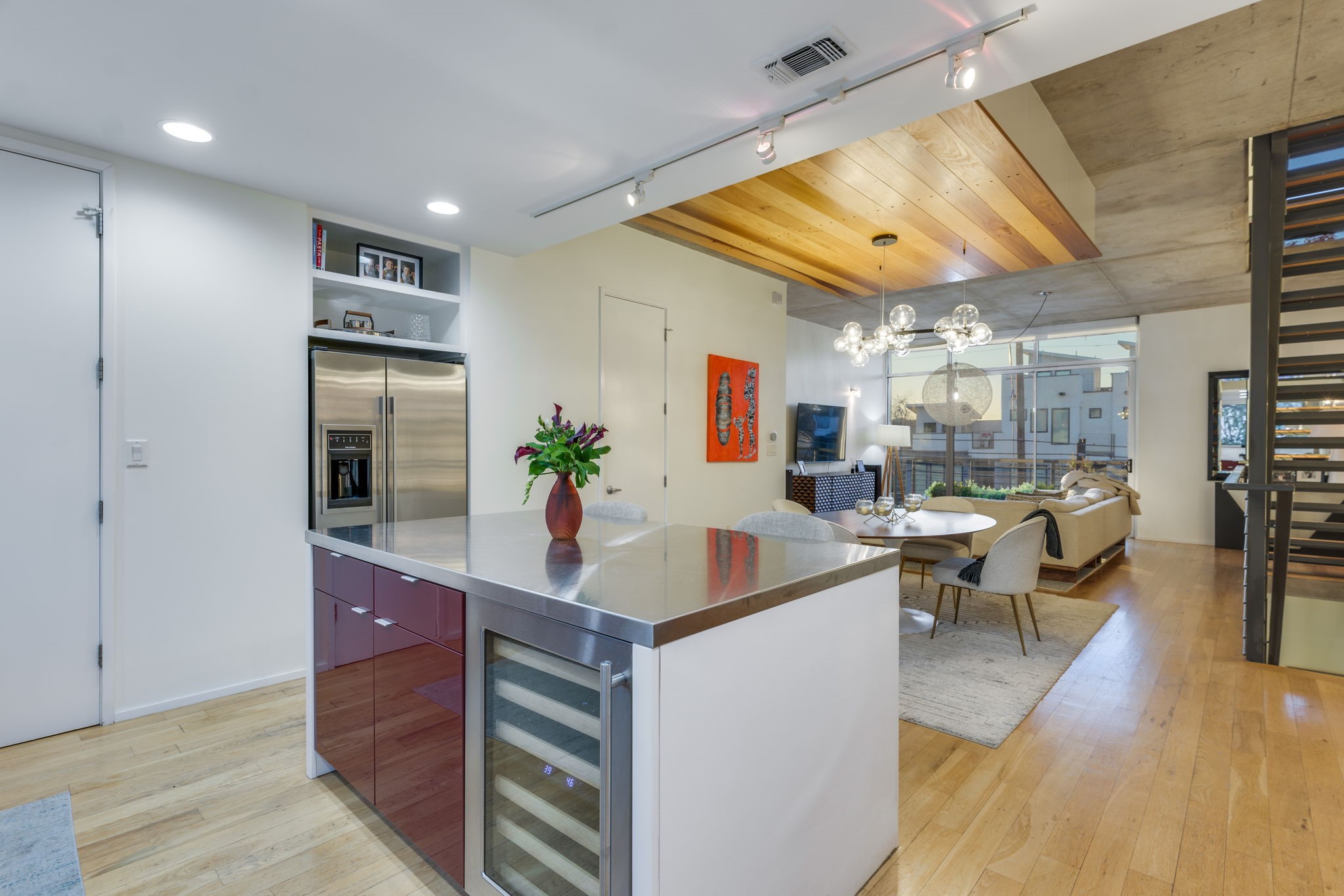2301 South 5th Street, Unit 5 Austin, TX 78704 - Photo 17 of 39 Kitchen featuring wine cooler, rail lighting, stainless steel counters, a large island, and light hardwood / wood-style floors